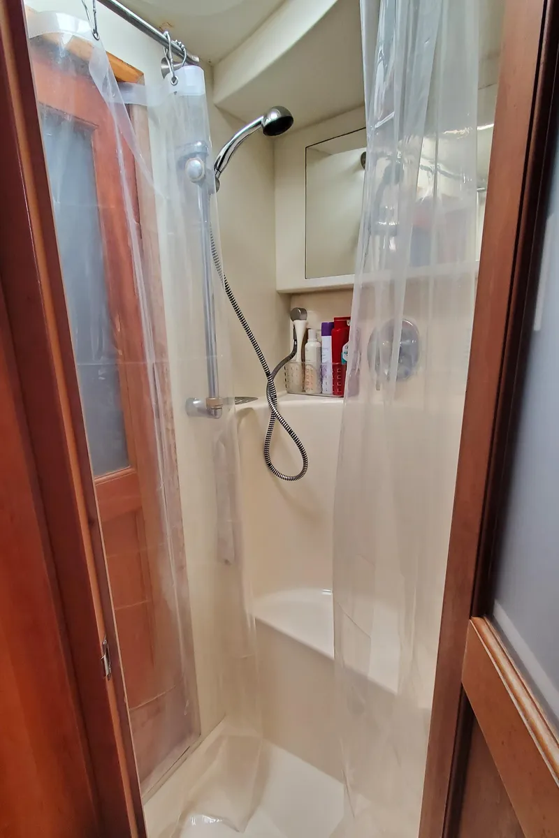 Slide: The Image of Shower area in 2003 Silverton 38 Convertible yacht with curtain and handheld showerhead. - 25