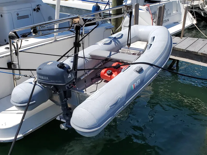 Slide: The Image of Inflatable boat with Yamaha motor docked beside 2003 Silverton 38 Convertible yacht. - 26