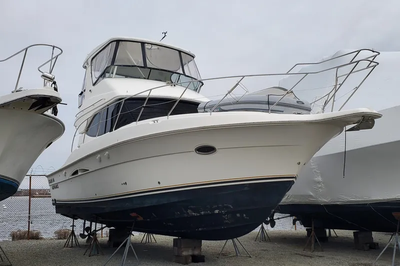 Slide: The Image of 2003 Silverton 38 Convertible boat on stands, displayed outdoors. - 28