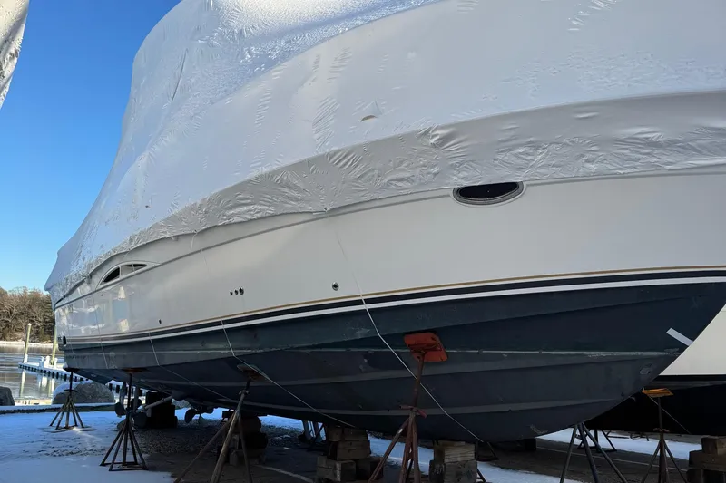 Slide: The Image of 2003 Silverton 38 Convertible boat covered and docked for winter storage. - 32