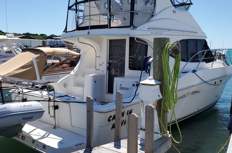Slide: The Image of 2003 Silverton 38 Convertible yacht docked at marina. - 5