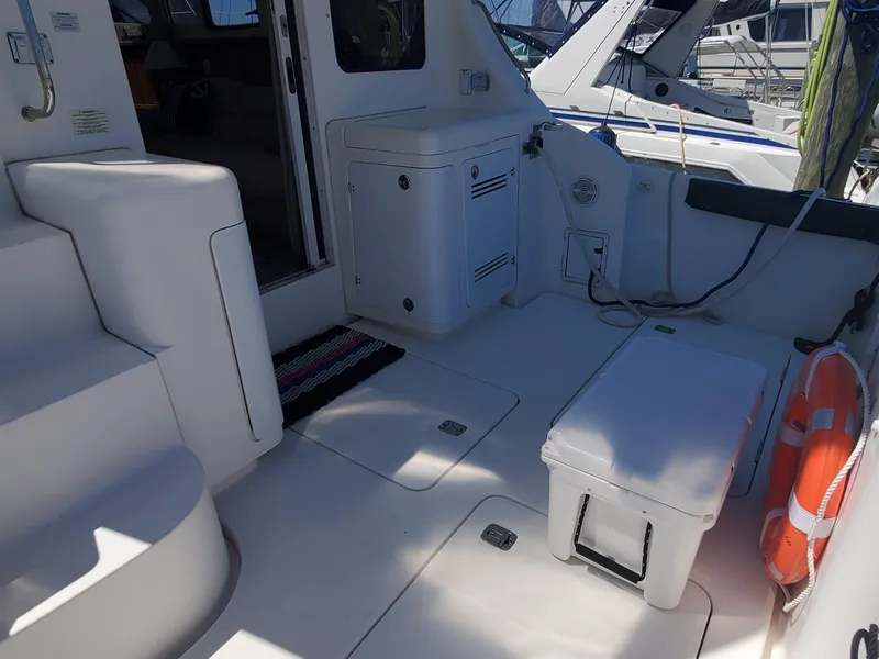 Slide: The Image of 2003 Silverton 38 Convertible yacht deck with seating and storage. - 7
