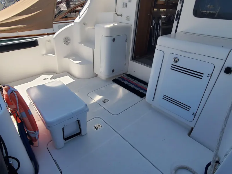 Slide: The Image of 2003 Silverton 38 Convertible yacht deck with storage compartments and seating. - 9