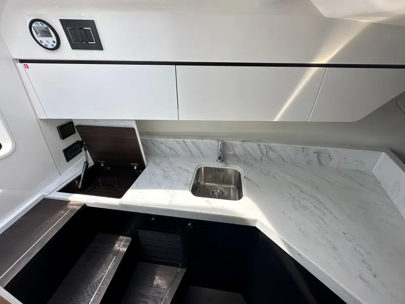 Slide: The Image of Interior of 2023 Fairline F//Line 33 Outboard yacht with modern seating and wooden table. - 27