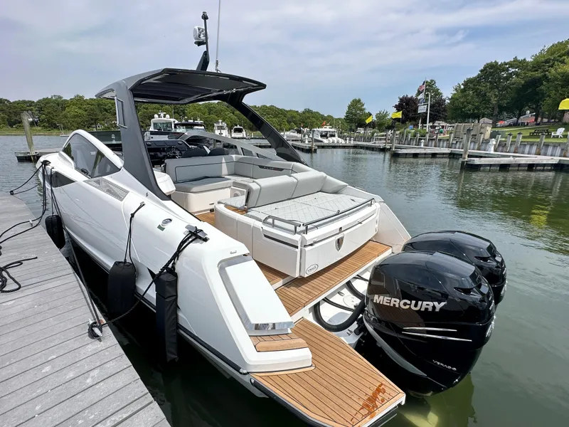 Slide: The Image of 2023 Fairline F//Line 33 Outboard luxury boat with cushioned seating and twin engines. - 7