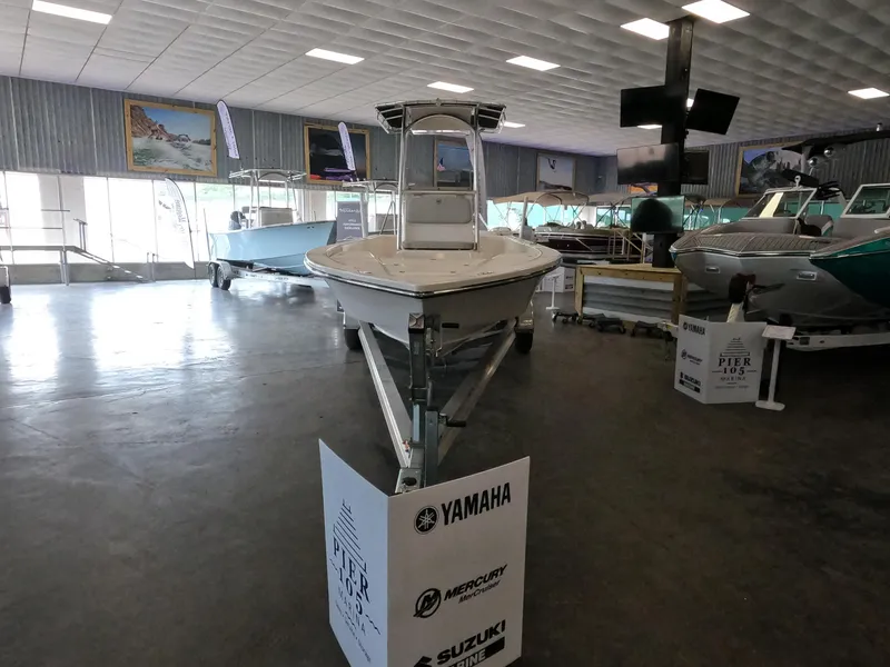 Slide: The Image of 2023 May-Craft 260 Bay boat displayed in a showroom. - 11