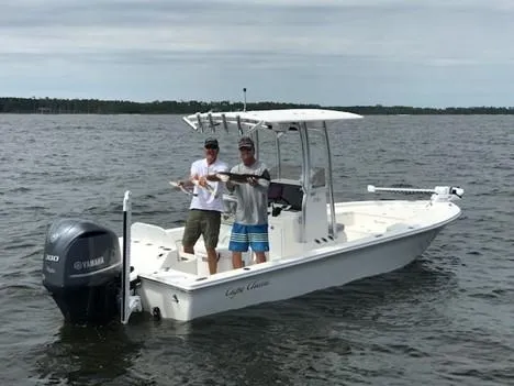 Slide: The Image of 2023 May-Craft 260 Bay boat with two people fishing on a lake. - 12