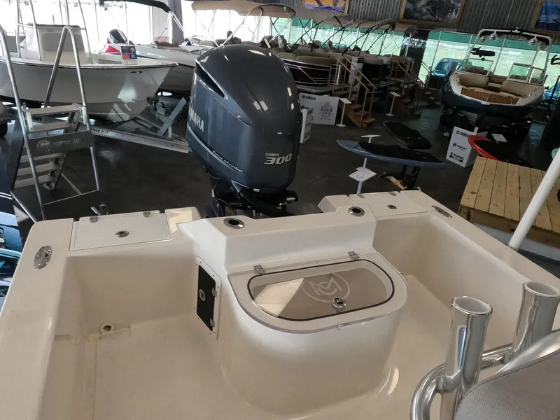 Slide: The Image of 2023 May-Craft 260 Bay boat with Yamaha 300 outboard motor in showroom. - 2