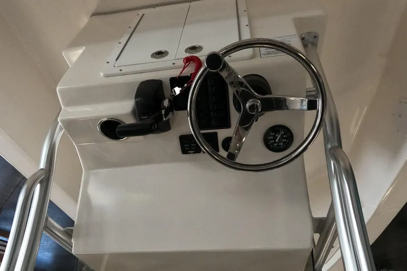 Slide: The Image of 2023 May-Craft 260 Bay boat helm with steering wheel and controls. - 5