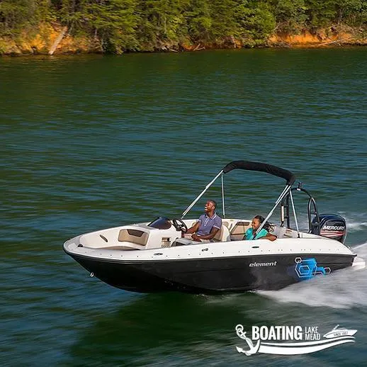 Slide: The Image of 2022 Bayliner E18 boat cruising on a lake with two passengers. - 10