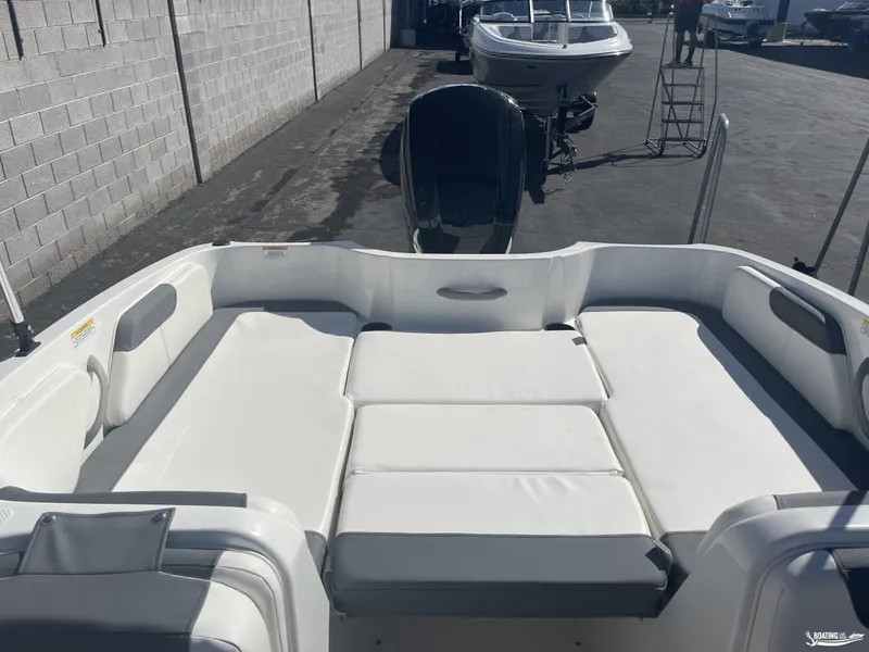 Slide: The Image of 2022 Bayliner E18 boat interior with spacious seating and modern design. - 7