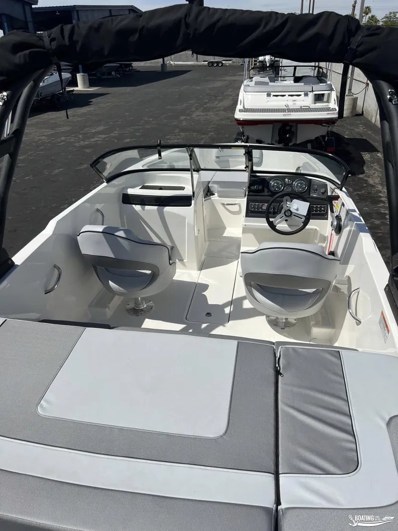 Slide: The Image of 2023 Bayliner VR6 Outboard boat interior with seating and steering console. - 11