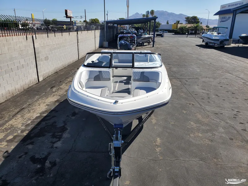 Slide: The Image of 2023 Bayliner VR6 Outboard boat on trailer in outdoor dealership lot. - 4