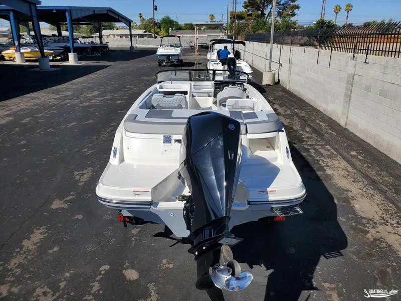 Slide: The Image of 2023 Bayliner VR6 Outboard boat in a marina, rear view showing engine and seating. - 5