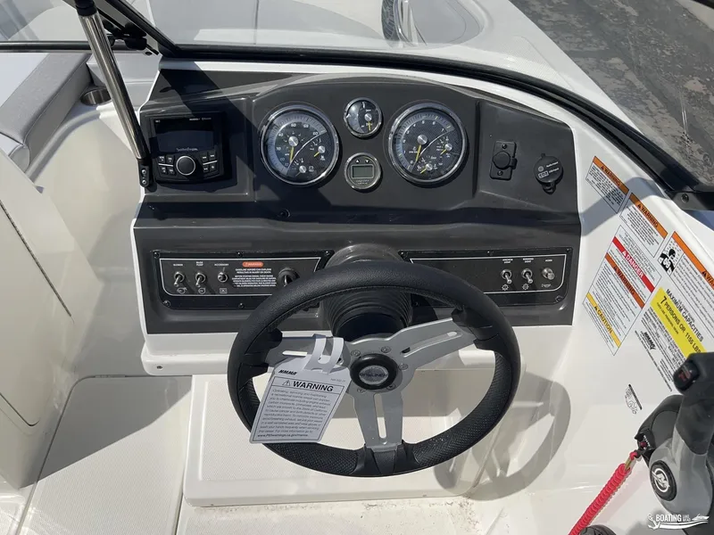 Slide: The Image of 2023 Bayliner VR6 Outboard dashboard with steering wheel and control panel. - 9