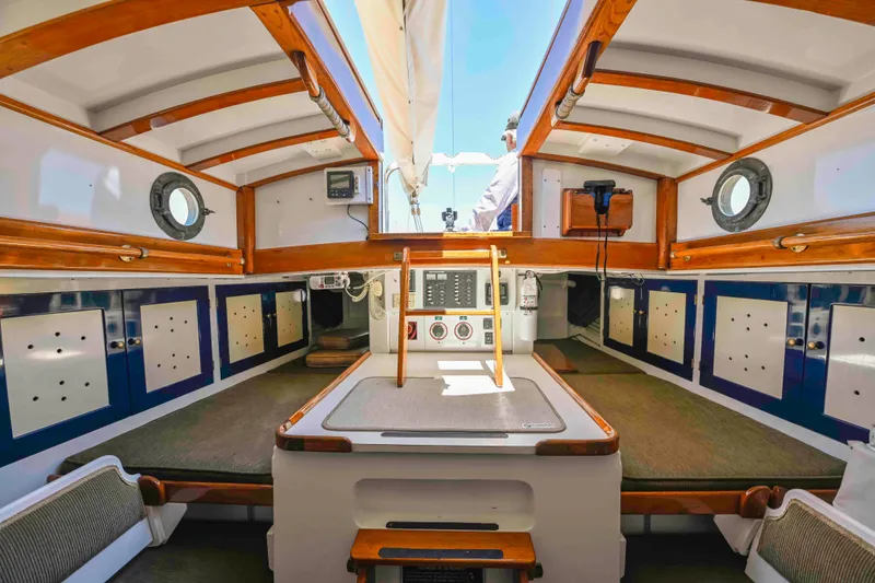 Slide: The Image of Interior of 1927 Schock Staysail Schooner with wooden accents and nautical design. - 10