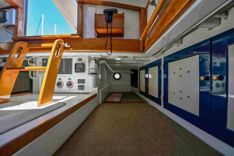 Slide: The Image of Interior of 1927 Schock Staysail Schooner, featuring wooden accents and nautical equipment. - 11