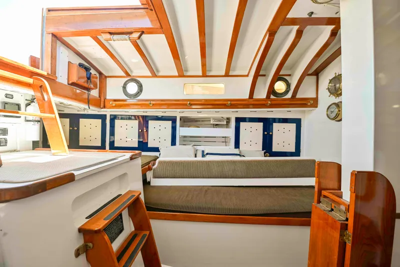 Slide: The Image of Interior of 1927 Schock Staysail Schooner with wooden beams and nautical decor. - 14