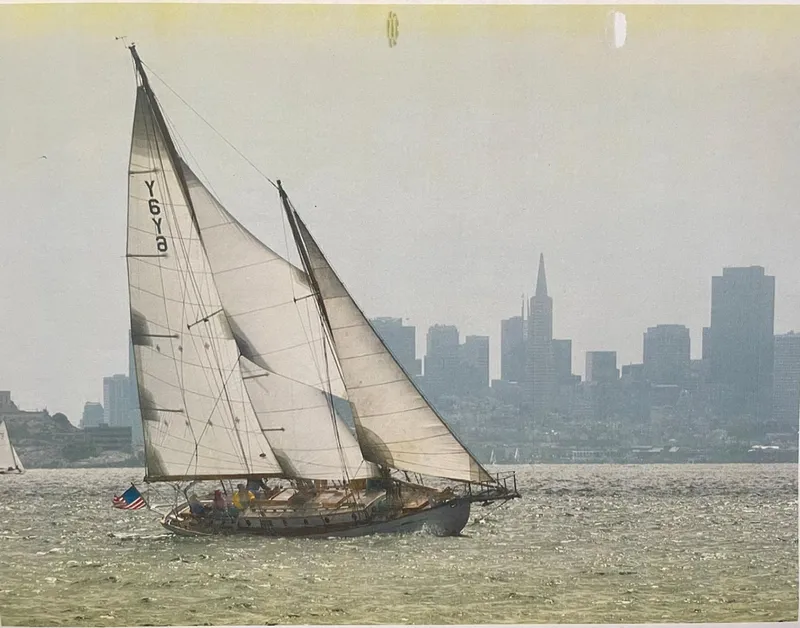 Slide: The Image of Vintage 1927 Schock Staysail Schooner sailing with city skyline backdrop. - 3