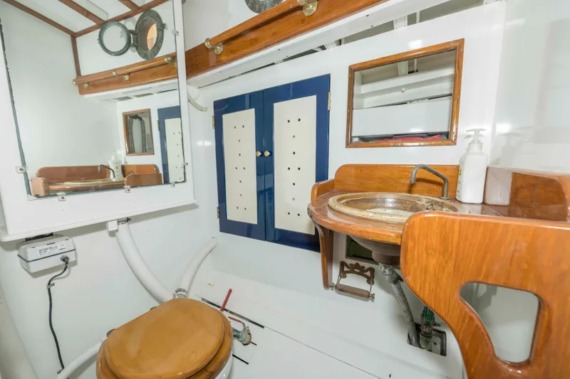 Slide: The Image of Vintage 1927 Schock Staysail Schooner bathroom with wooden accents and nautical decor. - 30