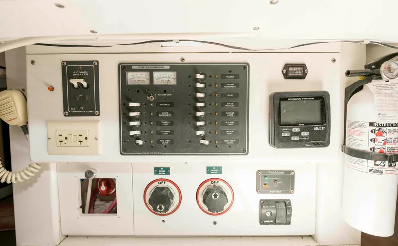 Slide: The Image of Electrical control panel on a 1927 Schock Staysail Schooner, featuring switches and a fire extinguisher. - 41