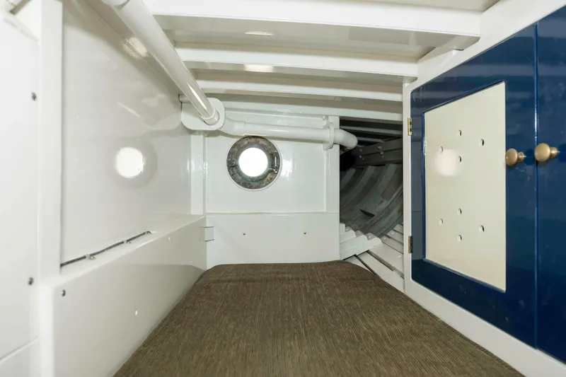 Slide: The Image of Interior cabin of 1927 Schock Staysail Schooner with porthole and storage. - 45