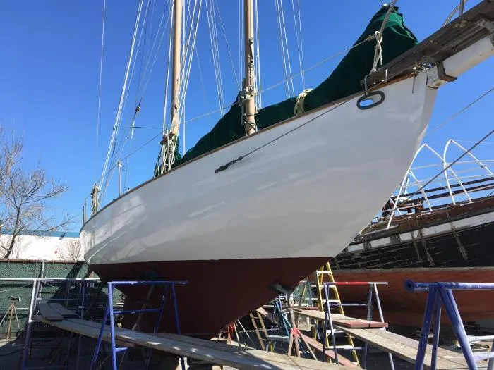Slide: The Image of 1927 Schock Staysail Schooner on dry dock, showcasing its sleek hull and classic design. - 5