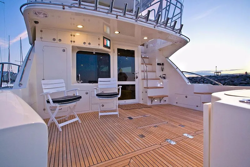 Slide: The Image of Luxurious deck of 2026 Mikelson 50 Generation II Sportfisher at sunset. - 12