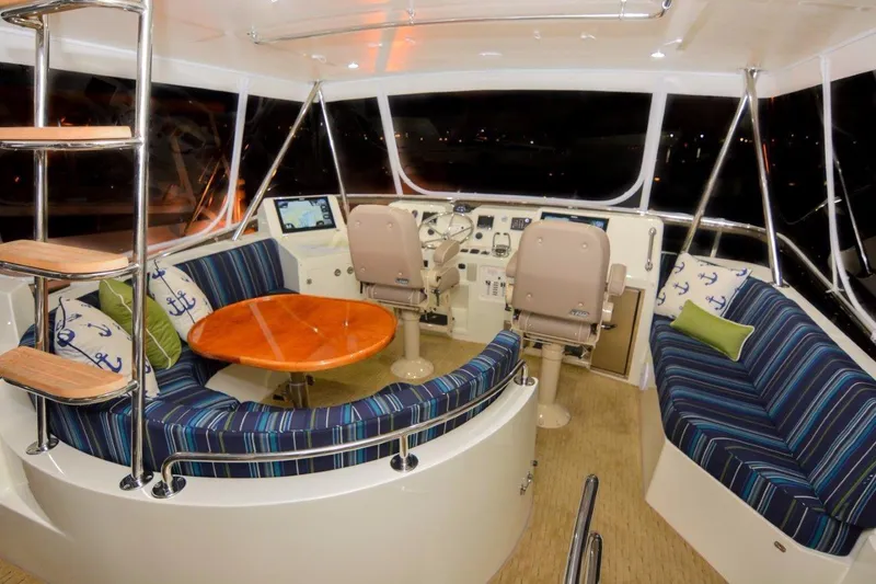 Slide: The Image of Luxurious interior of 2026 Mikelson 50 Generation II Sportfisher with plush seating and modern helm. - 9