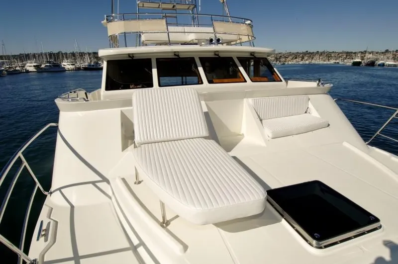 Slide: The Image of 2026 Mikelson Nomad Long Range Cruising Sportfish yacht with sun loungers on deck. - 12