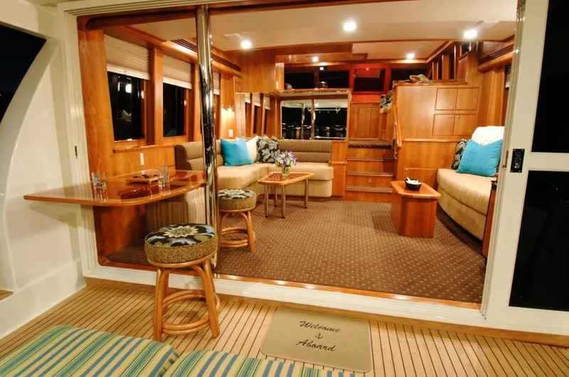 Slide: The Image of Luxurious interior of 2026 Mikelson Nomad Long Range Cruising Sportfish yacht, featuring elegant wood finishes. - 6