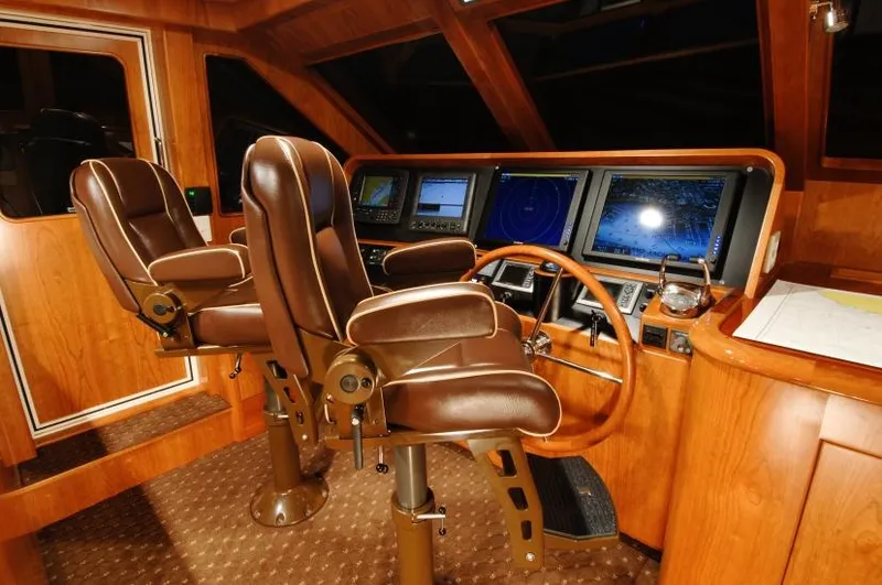 Slide: The Image of Pilothouse of 2026 Mikelson Nomad Long Range Cruising Sportfish with leather seats and navigation screens. - 8