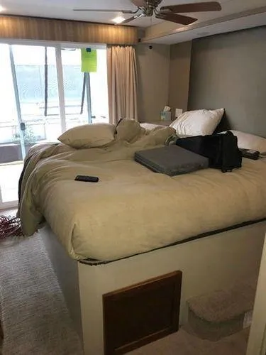 Slide: The Image of Cozy bedroom in 2015 Bravada Why Knot Week 10 houseboat with large bed and balcony view. - 17