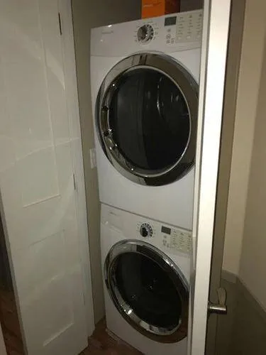 Slide: The Image of Stacked washer and dryer in a compact laundry closet. - 27