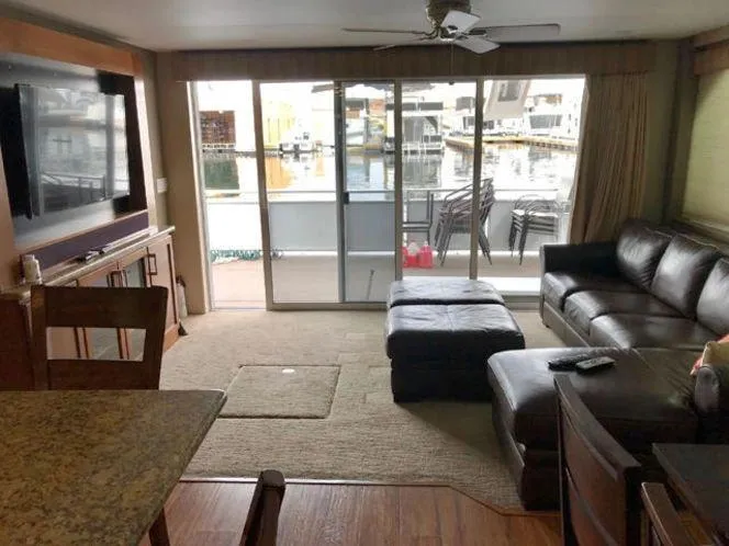 Slide: The Image of Interior of 2015 Bravada Why Knot Week 10 houseboat with modern furnishings and marina view. - 28