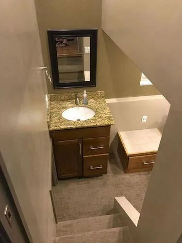 Slide: The Image of Compact bathroom with granite countertop and wooden cabinets in Bravada Why Knot Week 10, 2015 model. - 29