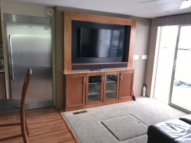 Slide: The Image of Modern living area in 2015 Bravada Why Knot Week 10 houseboat with TV and stainless steel fridge. - 9