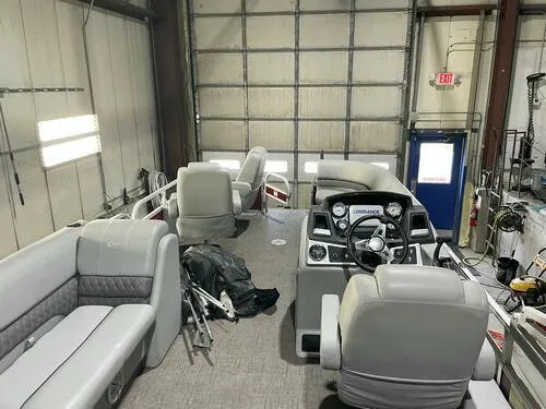Slide: The Image of 2019 Ranger 220FC pontoon boat interior in a garage. - 11