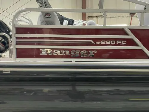 Slide: The Image of 2019 Ranger 220FC boat side view in a showroom. - 13