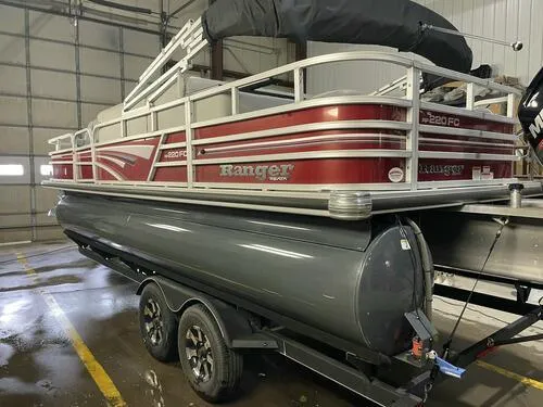 Slide: The Image of 2019 Ranger 220FC pontoon boat on trailer in indoor storage. - 3
