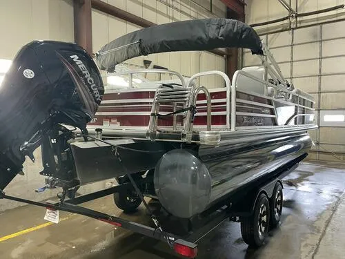 Slide: The Image of 2019 Ranger 220FC pontoon boat with Mercury outboard motor in a garage. - 4
