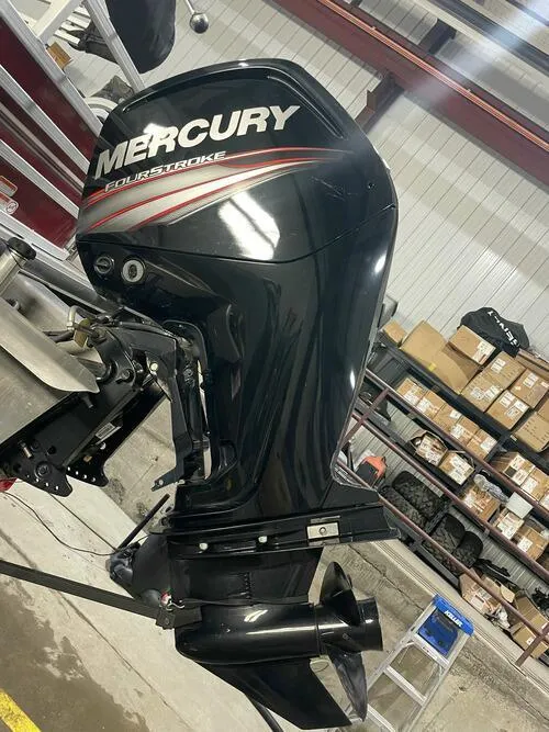 Slide: The Image of 2019 Ranger 220FC boat with a Mercury FourStroke outboard motor in a workshop. - 6