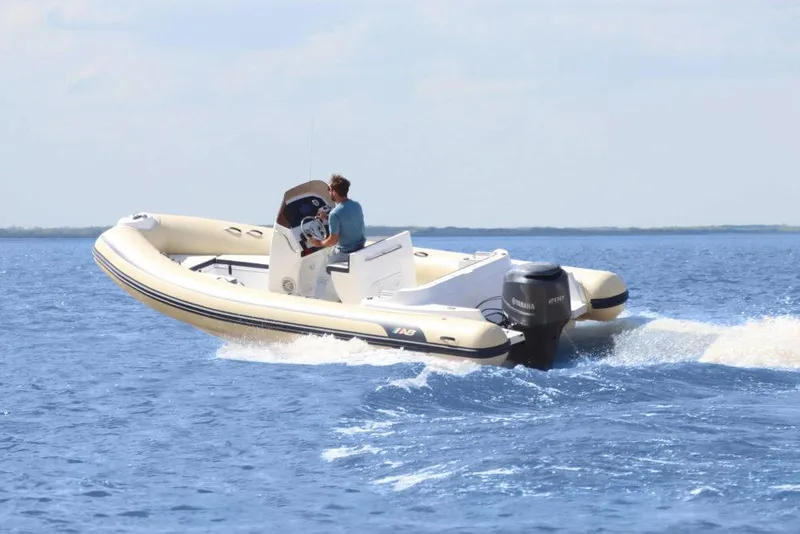 Slide: The Image of 2024 AB Inflatables 21 VST boat cruising on open water. - 0