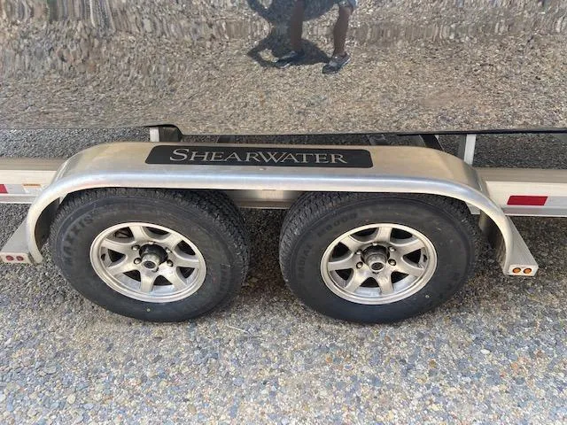 Slide: The Image of ShearWater 26 Carolina 2014 boat trailer with dual wheels and ShearWater branding. - 11