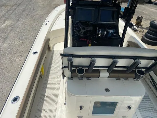 Slide: The Image of 2014 ShearWater 26 Carolina boat interior with console and rod holders. - 13