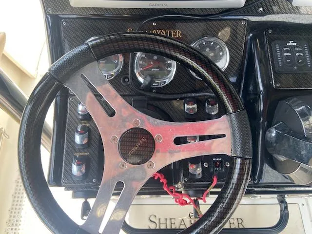 Slide: The Image of Steering wheel and dashboard of a 2014 ShearWater 26 Carolina boat. - 16