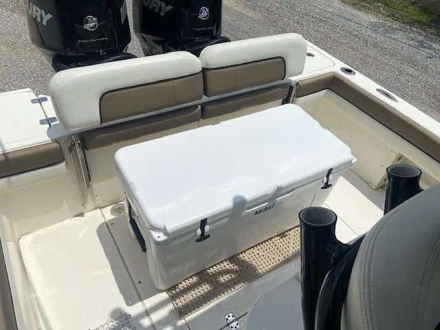 Slide: The Image of 2014 ShearWater 26 Carolina boat with dual Mercury engines and a white cooler. - 18