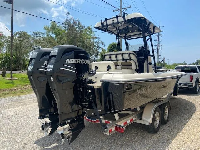 Slide: The Image of 2014 ShearWater 26 Carolina boat with twin Mercury 200 engines on a trailer. - 2