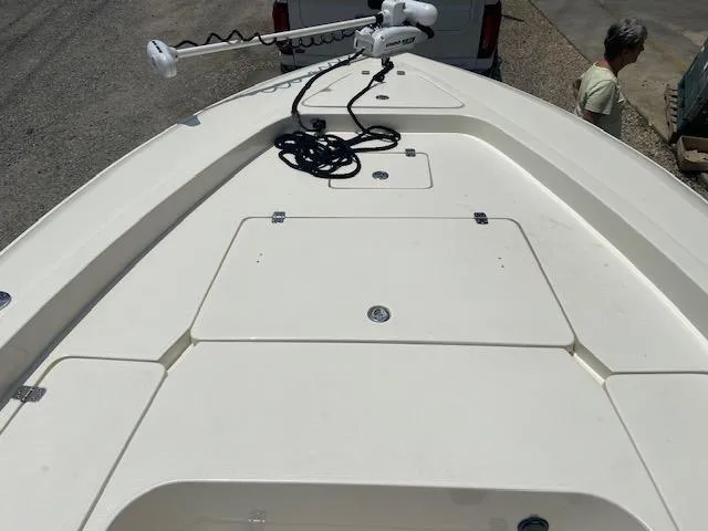 Slide: The Image of 2014 ShearWater 26 Carolina boat deck with storage compartments and trolling motor. - 22