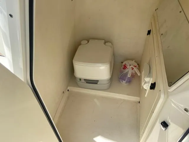 Slide: The Image of 2014 ShearWater 26 Carolina boat interior with portable toilet - 26